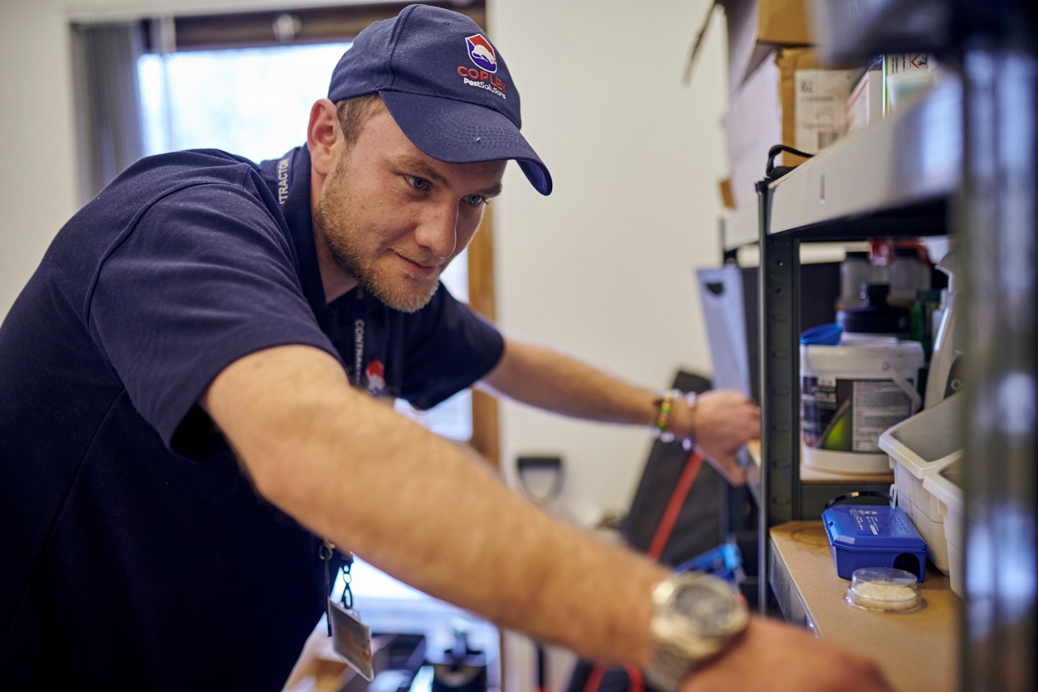 Copley pest technician wearing a branded hat