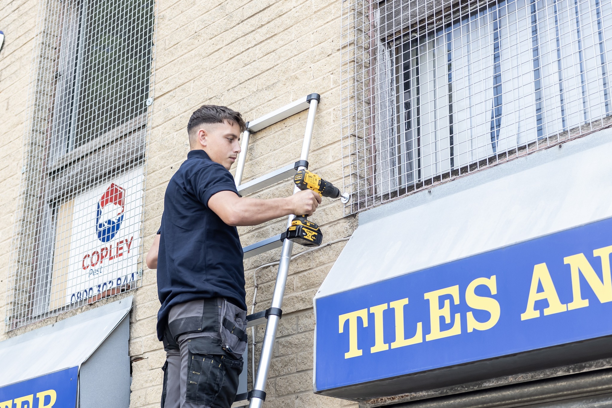 An installer fitting bird netting